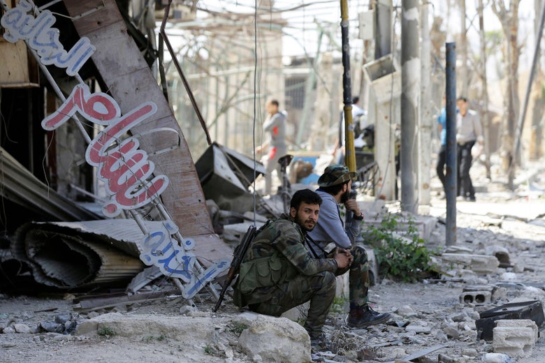 A Syrian government soldier sits in the rubble of a building in Douma on the outskirts of Damascus on April 16, 2018 during an organised media tour after the Syrian army declared that all anti-regime forces have left Eastern Ghouta, following a blistering two month offensive on the rebel enclave.
The announcement, which represents a key strategic victory for President Bashar al-Assad, came just hours after US-led strikes pounded Syrian government targets in response to a suspected chemical attack on the enclave's main town of Douma.
/ AFP PHOTO / LOUAI BESHARA (Photo credit should read LOUAI BESHARA/AFP/Getty Images)